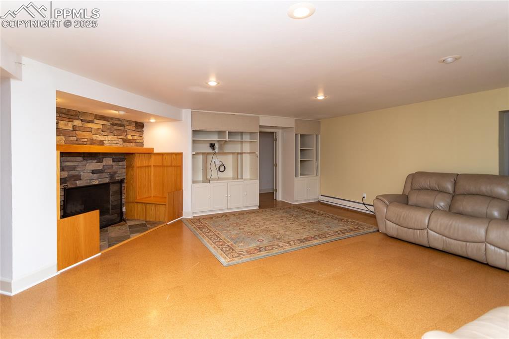 Image 39 of 50: Basement living room with fireplace and couch