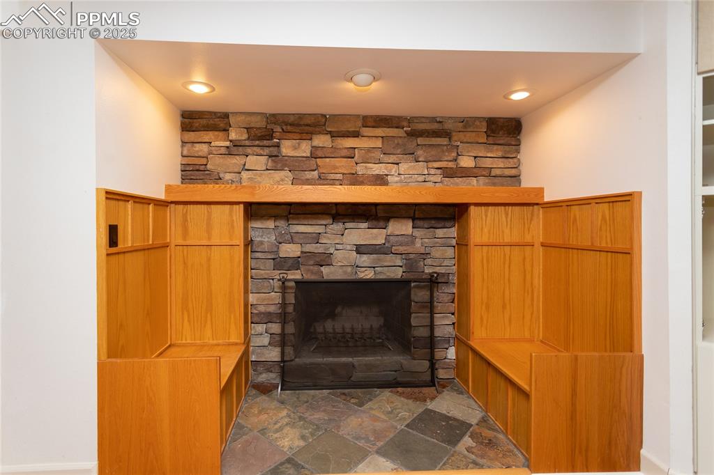 Image 40 of 50: Wood burning fireplace with built-in benches