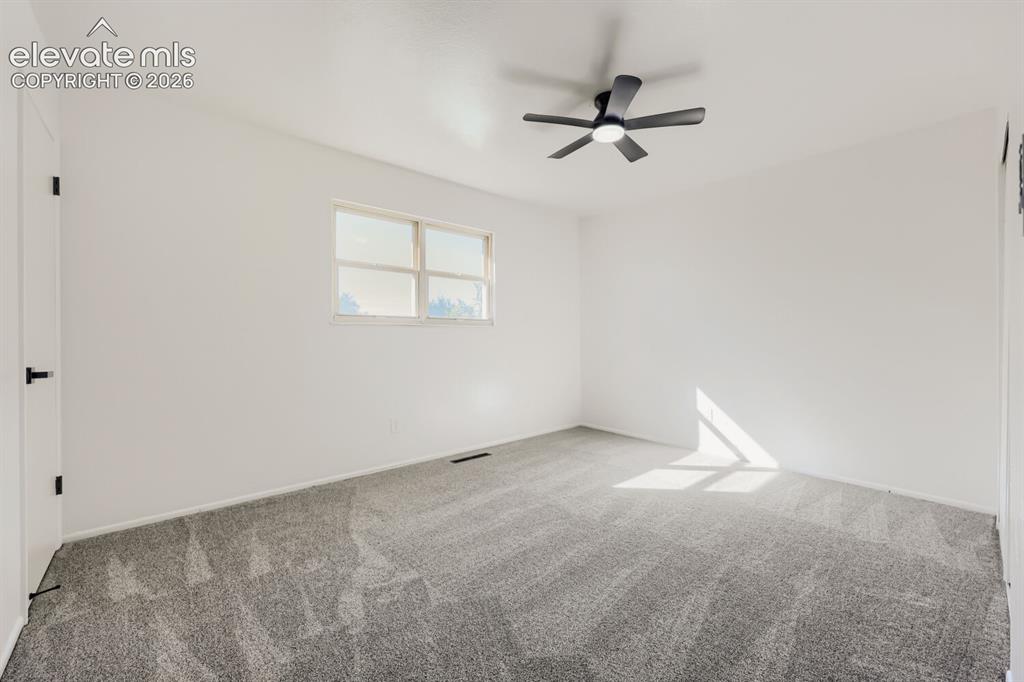 Image 10 of 22: Window with natural light, neutral wall colors, textured carpeting, and a c