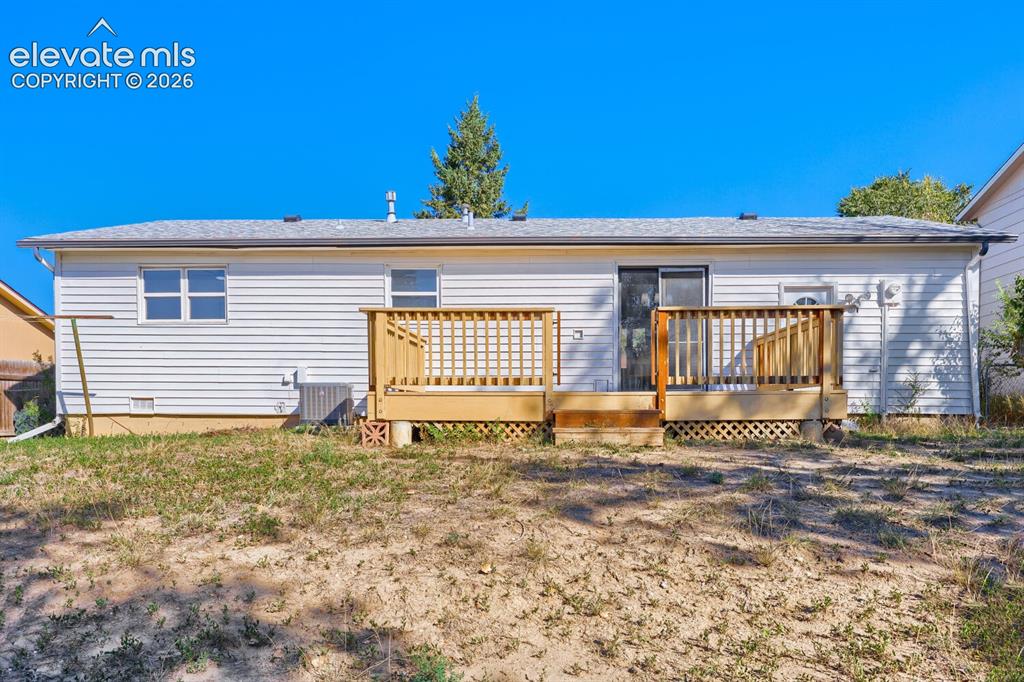 Image 20 of 22: Exterior featuring white siding, a full-length deck with wooden railing, a