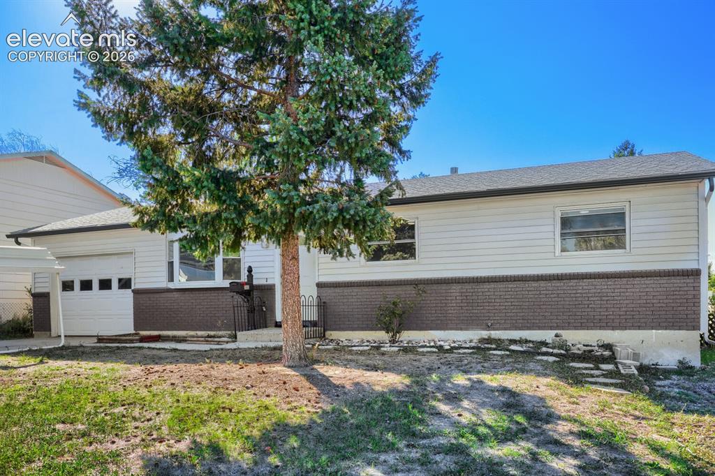 Image 3 of 22: Exterior siding with brick accent, asphalt shingle roofing, attached garage