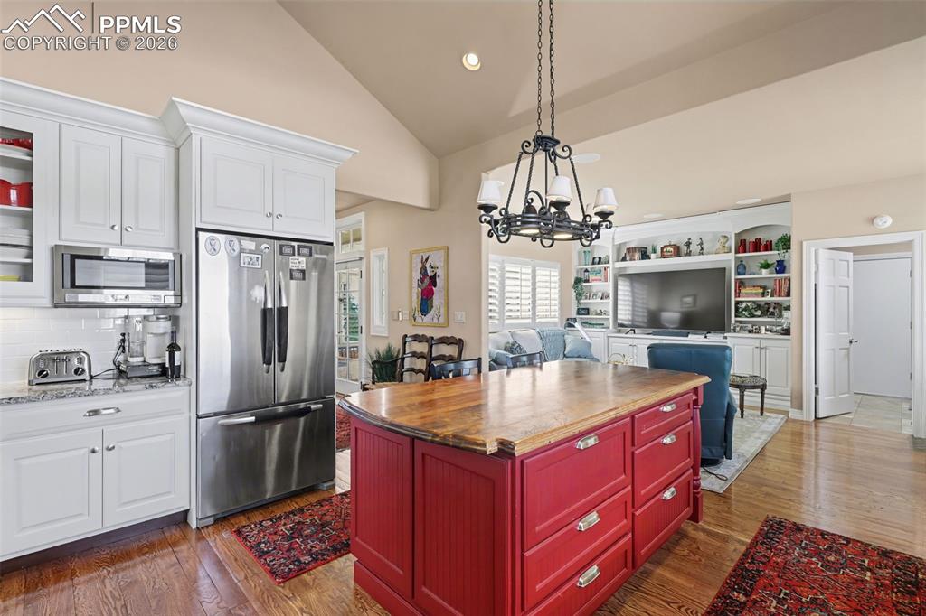 Image 18 of 50: The gas fireplace adds a cozy feel to this elegant room. 