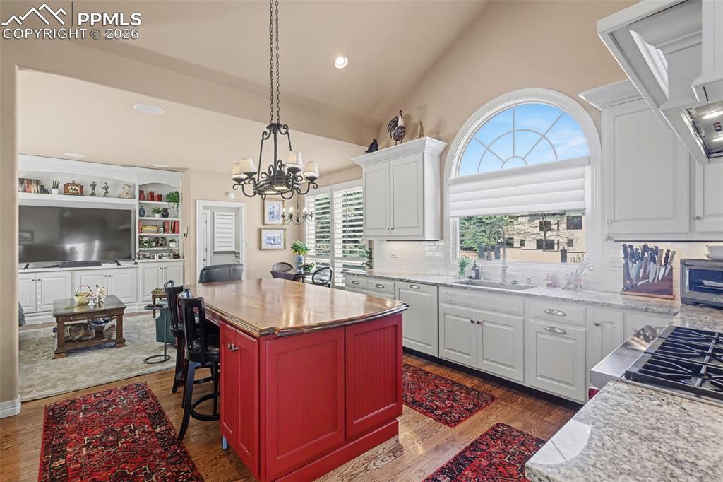 Image 19 of 50: Kitchen adjoins hearth room with door to the laundry and a large walk-in pa