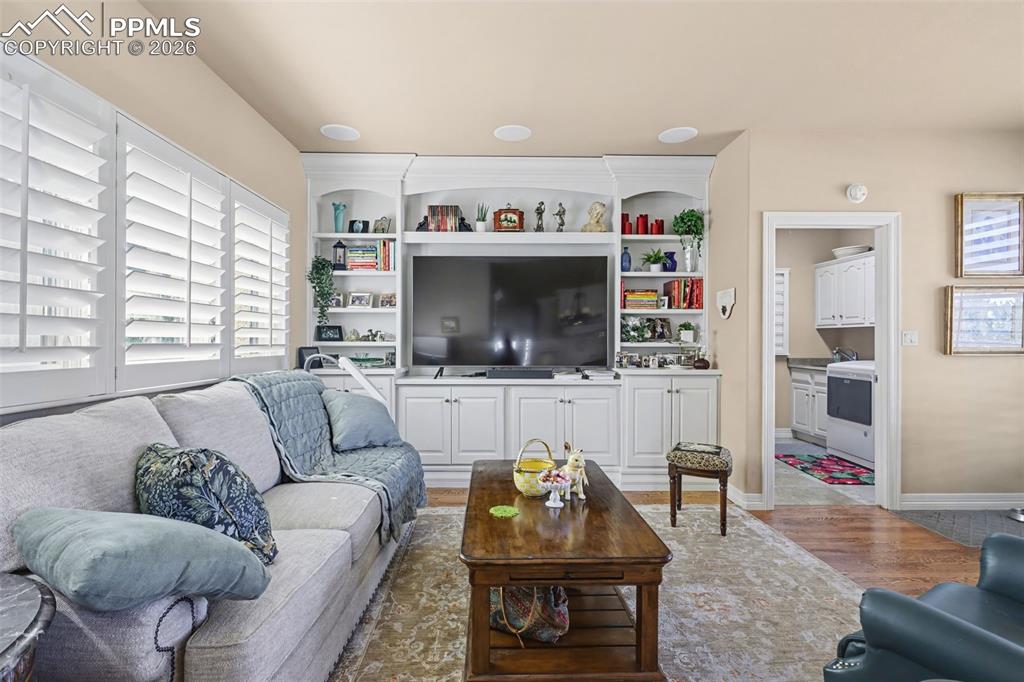 Image 23 of 50: Hearth room off kitchen features a built-in entertainment center and easy a
