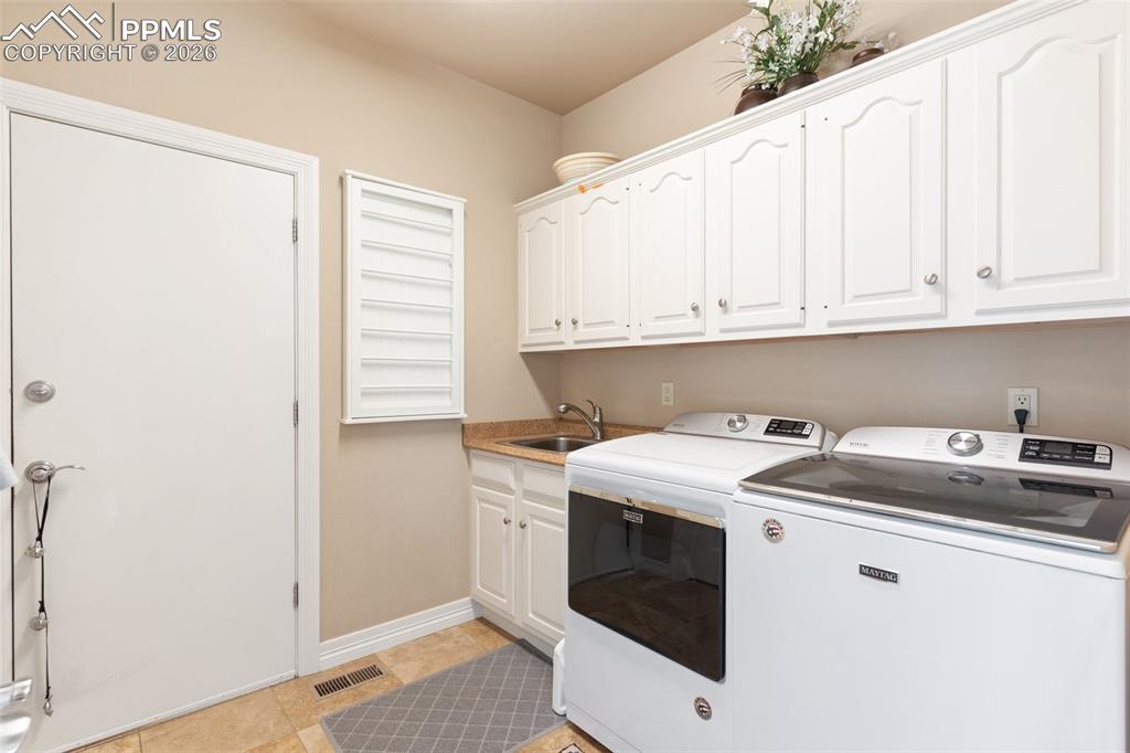 Image 26 of 50: Wonderful laundry room with garage access and an oversized pantry.