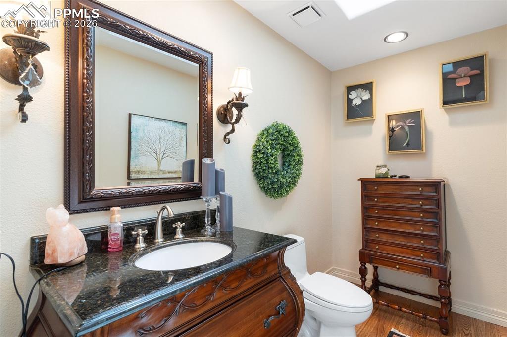 Image 29 of 50: Lovely main level powder room is adjacent to the office.