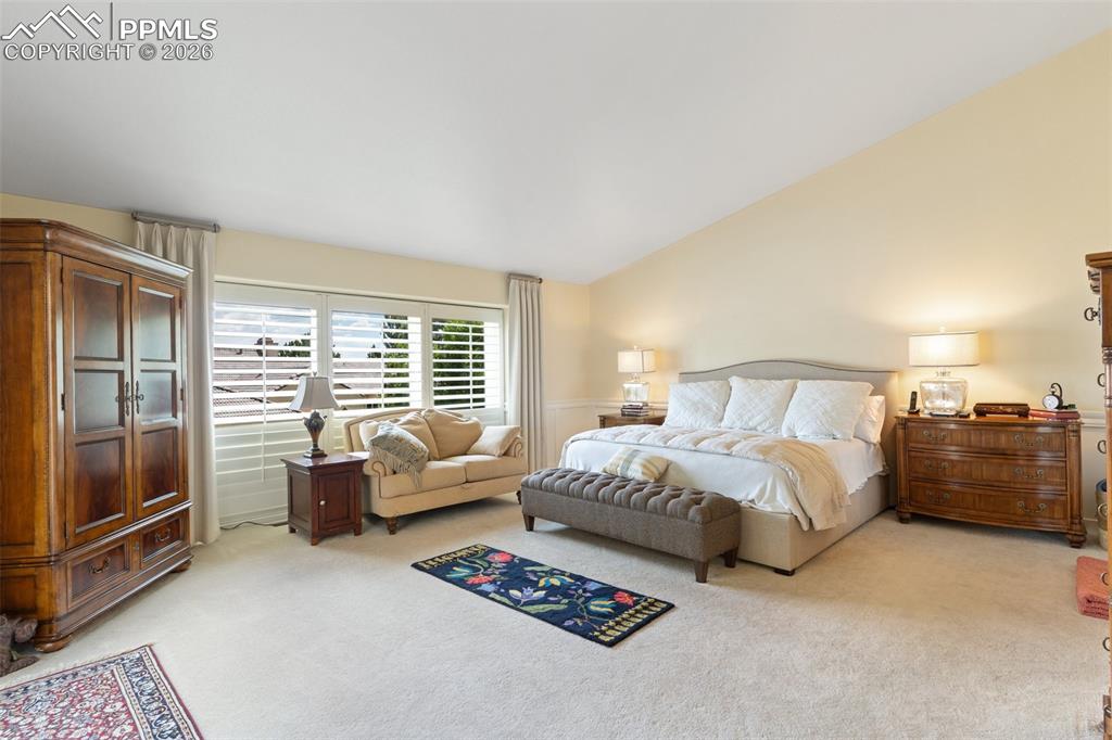 Image 31 of 50: Spacious primary bedroom with access to the patio is that tranquil retreat