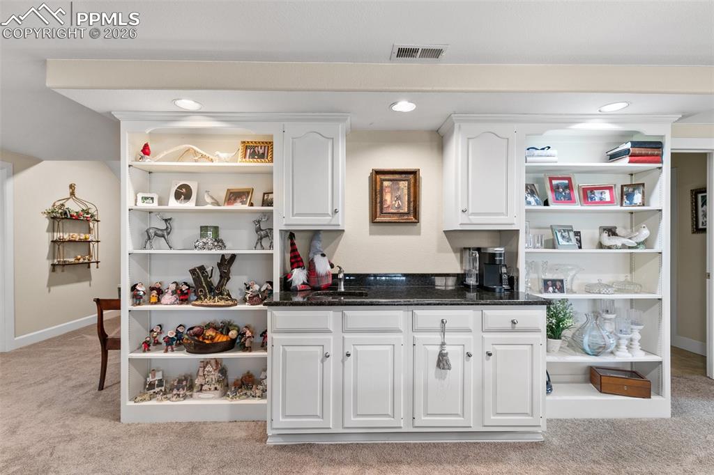 Image 38 of 50: Display all your favorite keepsakes on the built-in shelves and offer a toa