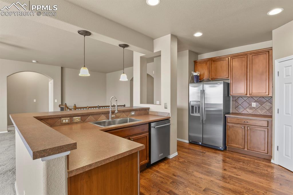 Image 11 of 42: Kitchen with hardwood floors