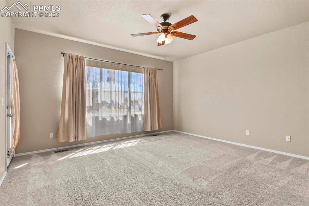 Image 16 of 42: Main floor Primary Bedroom with a private walkout to the balcony