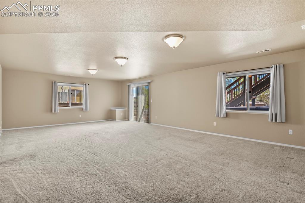 Image 26 of 42: Family room with a walkout to the exterior patio