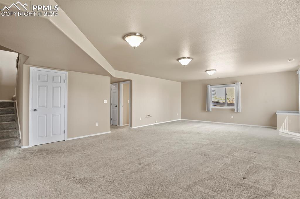 Image 27 of 42: Family room with a walkout to the exterior patio