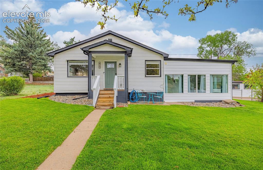 Caption: White horizontal siding exterior with dark trim and a prominent front gable