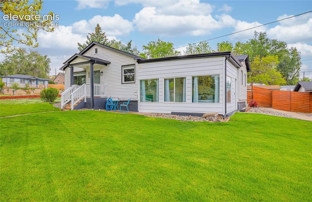 Image 15 of 46: White siding exterior with black trim accents