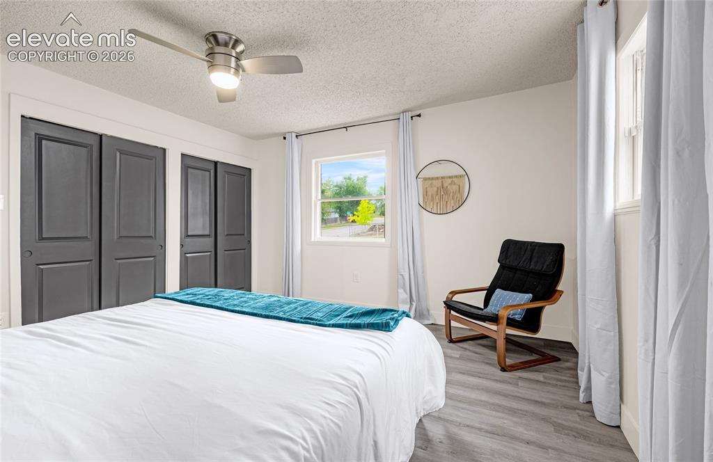 Image 28 of 46: Neutral wall finishes, wood-finish flooring, two sets of bi-fold closet doo