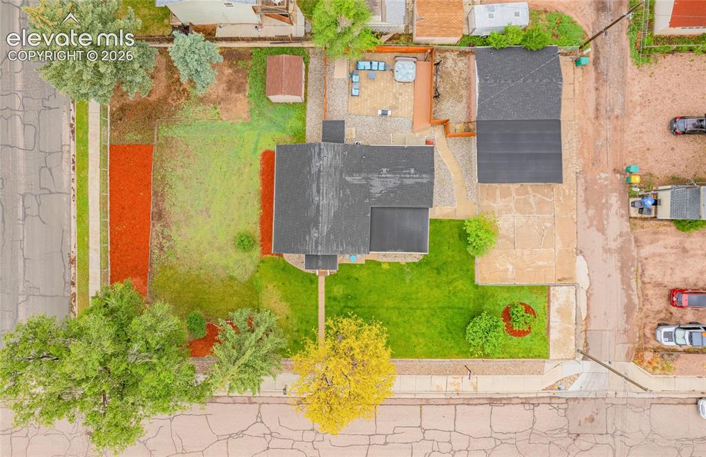 Image 42 of 46: Property featuring a dark-toned roof, front lawn, concrete driveway, and a 