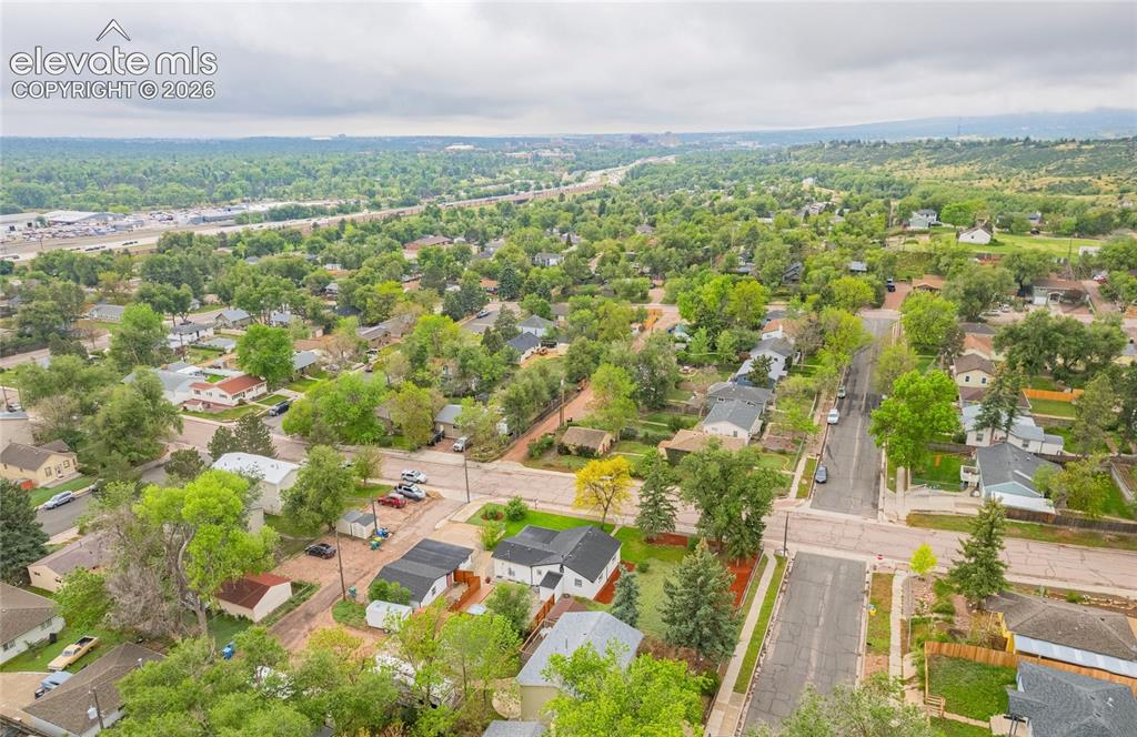 Image 46 of 46: Aerial perspective showcasing a residential area with mature trees and a st