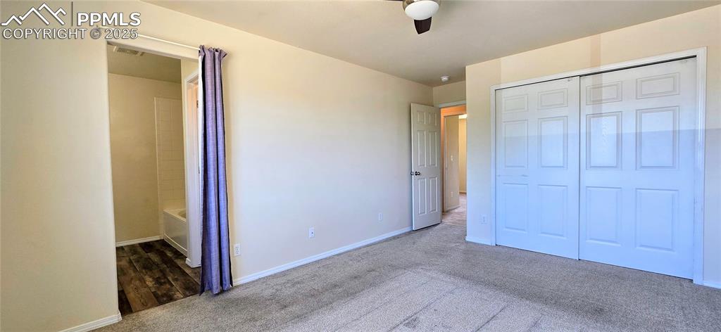 Image 11 of 24: Unfurnished bedroom featuring carpet floors, a closet, and ceiling fan