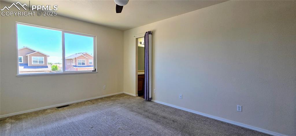 Image 12 of 24: Carpeted empty room featuring ceiling fan and baseboards