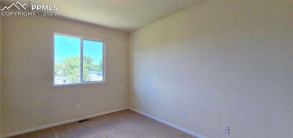 Image 13 of 24: Unfurnished room with baseboards and light colored carpet