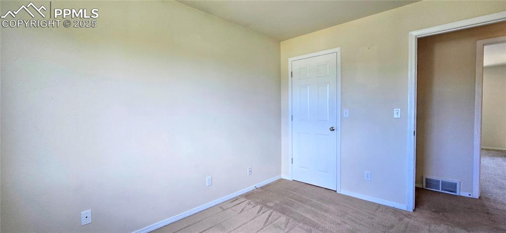 Image 14 of 24: Unfurnished bedroom with carpet flooring and baseboards
