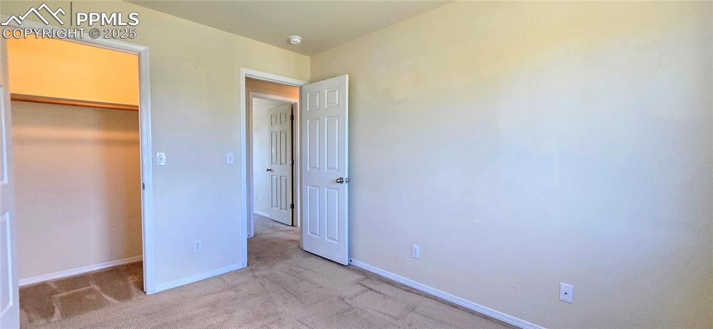 Image 15 of 24: Unfurnished bedroom featuring baseboards and carpet floors