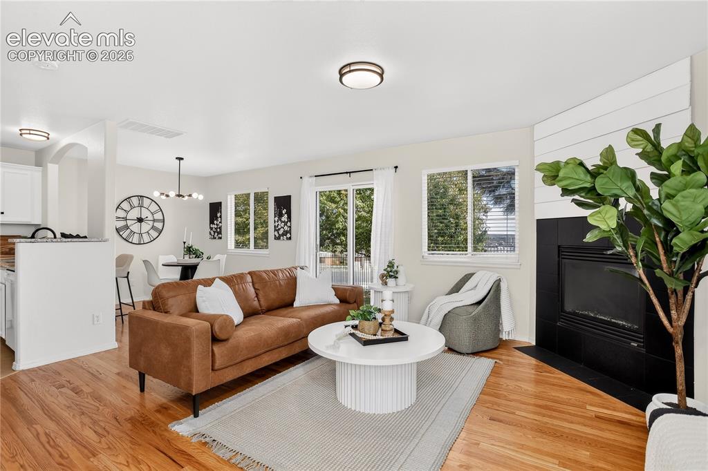 Image 11 of 35: Living room with gas fireplace and walk out to back yard. 