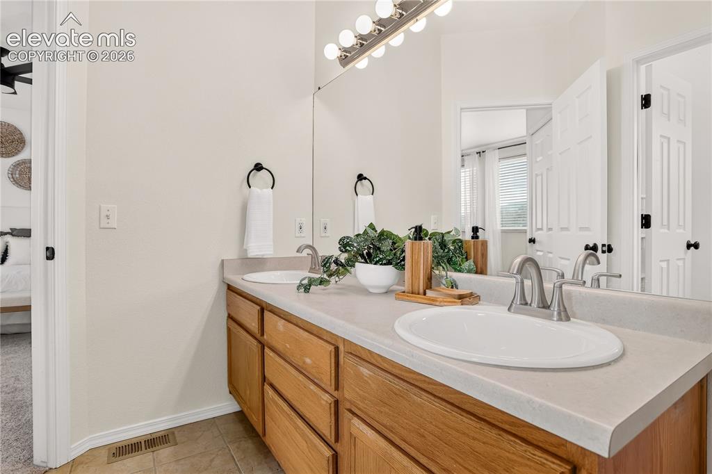 Image 19 of 35: Master bathroom with double vanity.