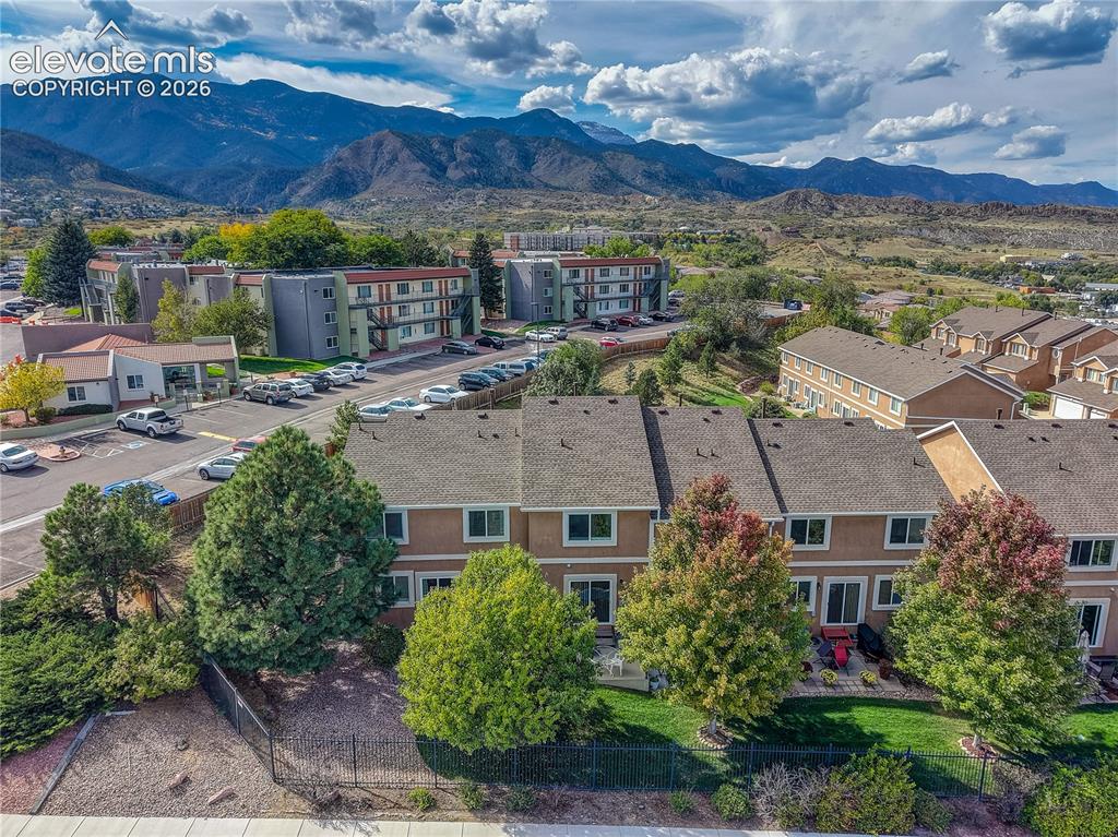 Image 2 of 35: Aerial view of townhome with mountain views and mature trees!