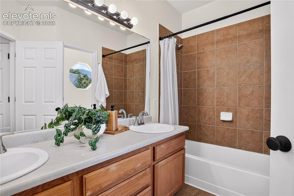 Image 20 of 35: Master bathroom with double vanity and tub/shower. 