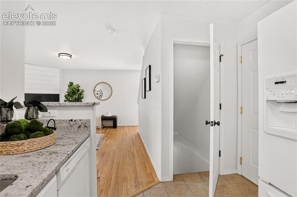 Image 26 of 35: Entry to basement level and garage from kitchen.