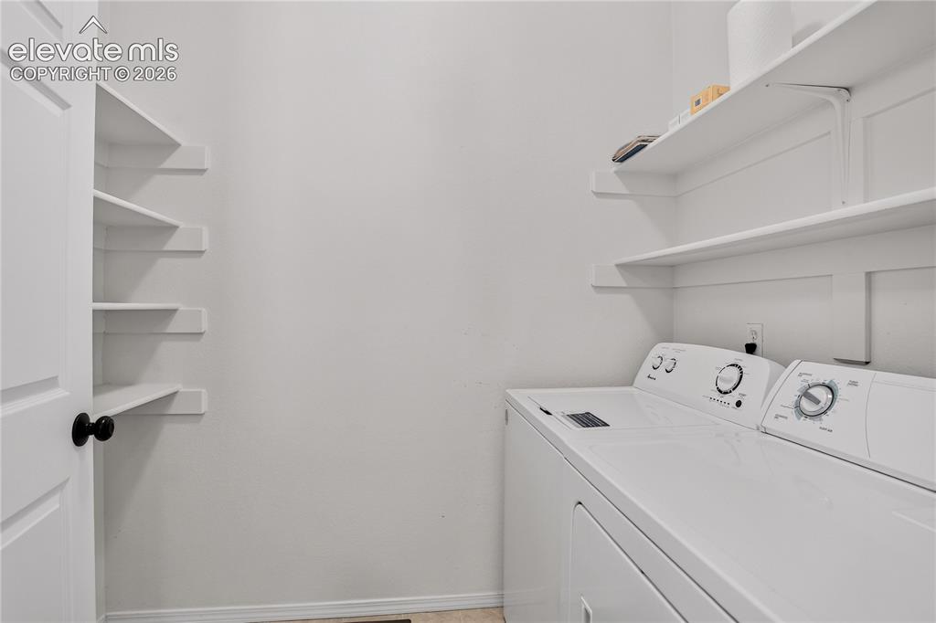 Image 29 of 35: Laundry room with ample shelving space. 