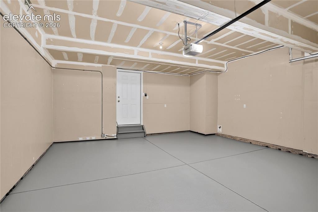 Image 32 of 35: Two car garage with fresh epoxy coating. 