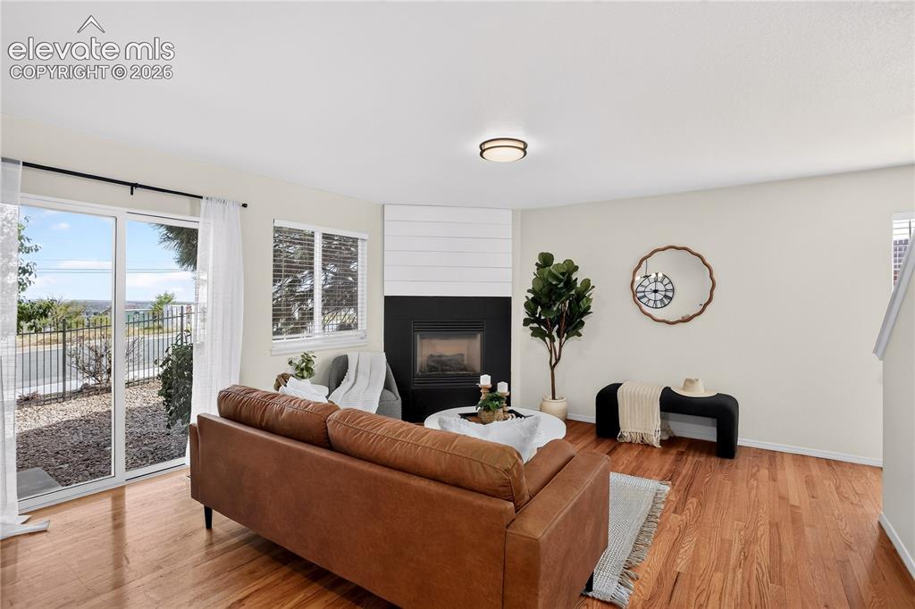 Image 9 of 35: Living room with gas fireplace and walk out to back yard.