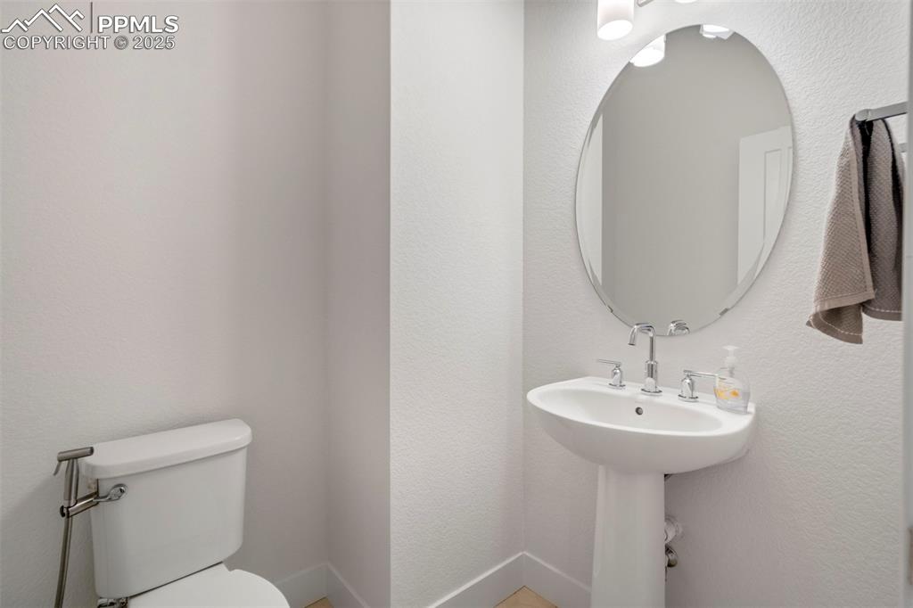 Image 14 of 45: Bathroom with a textured wall and toilet