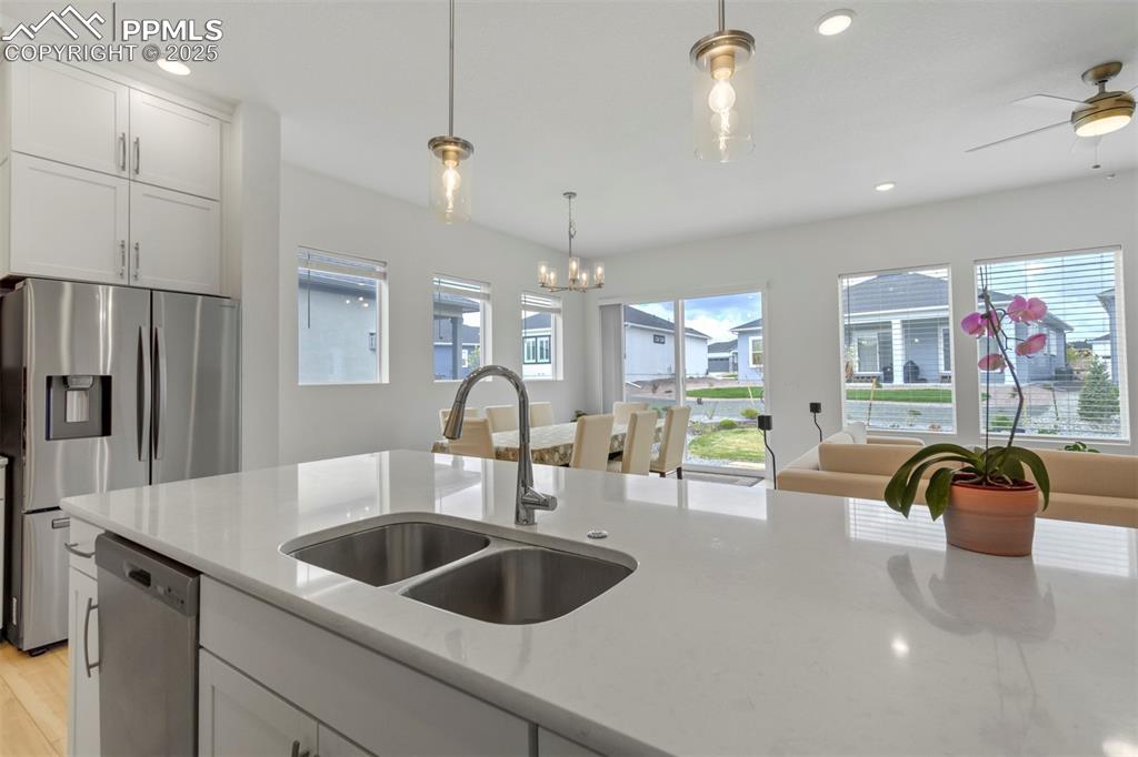 Image 22 of 45: Kitchen featuring stainless steel appliances, white cabinetry, recessed lig