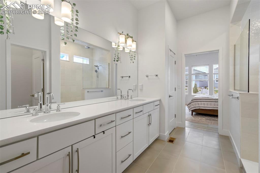 Image 28 of 45: Ensuite bathroom with walk in shower, plenty of natural light, double vanit