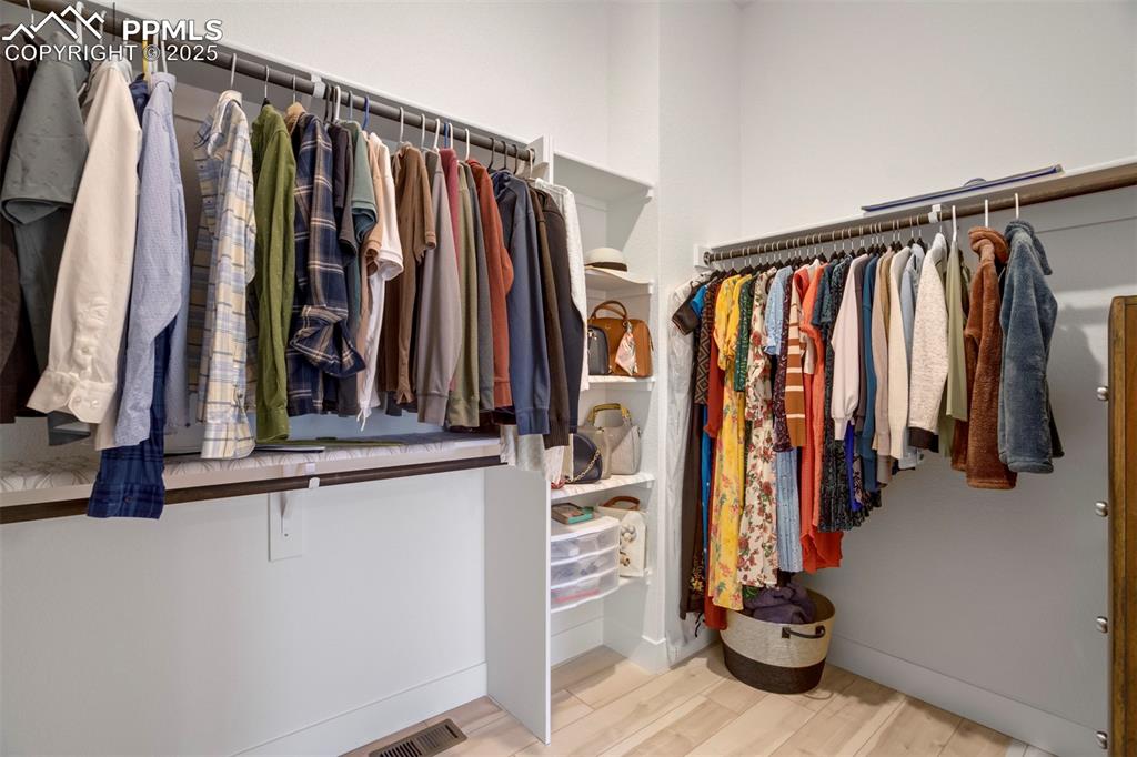 Image 33 of 45: Walk in closet with light wood-type flooring