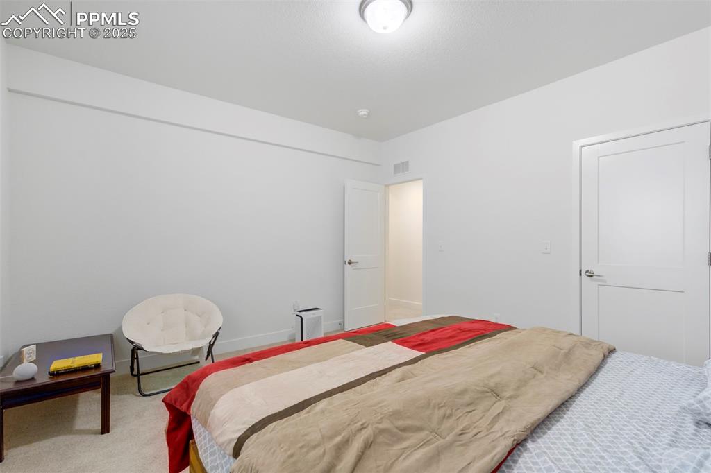 Image 38 of 45: Carpeted bedroom with baseboards