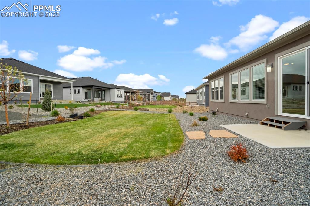 Image 42 of 45: View of yard featuring a residential view and a patio