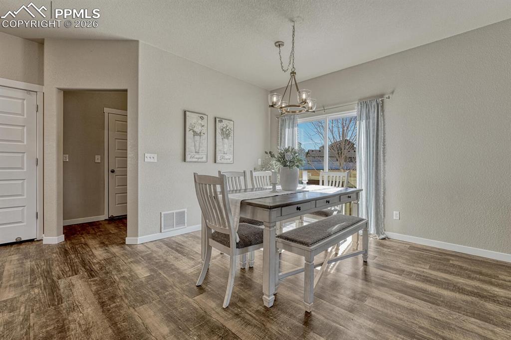 Image 12 of 50: Dining room walks out to yard and patio