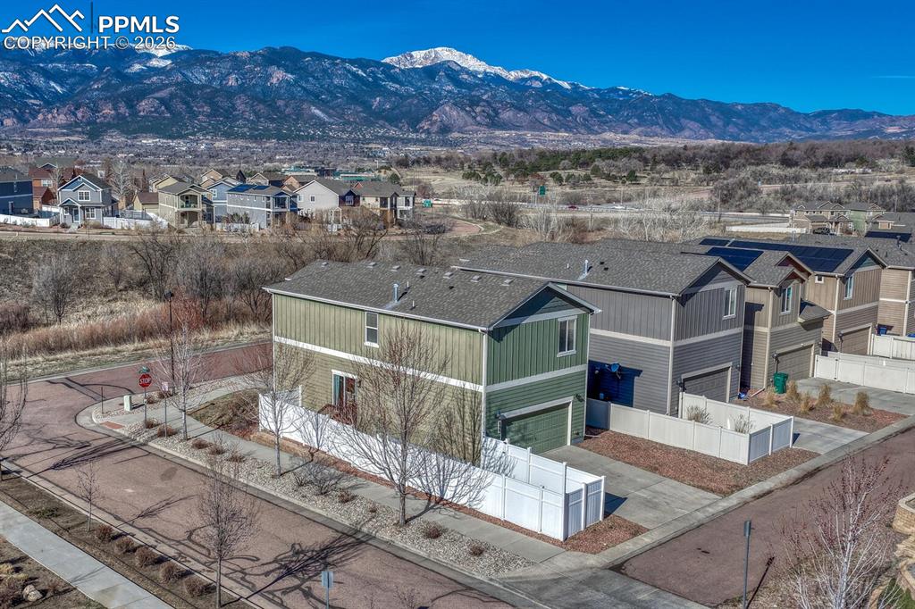 Image 3 of 50: Fenced yard and attached garage with alley access