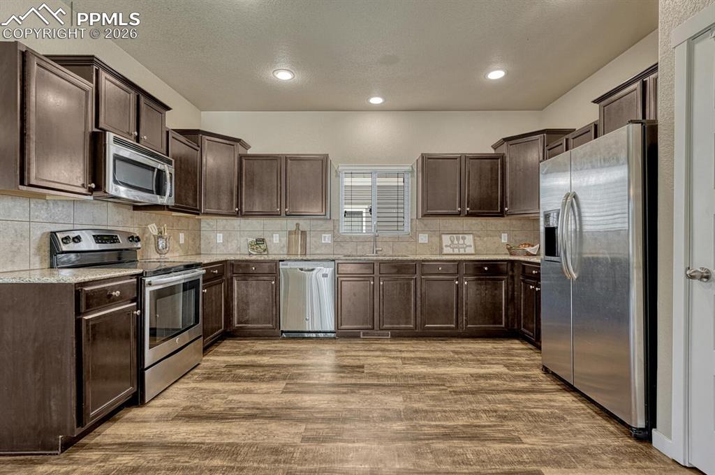 Image 8 of 50: Large open kitchen with staggered cabinetry