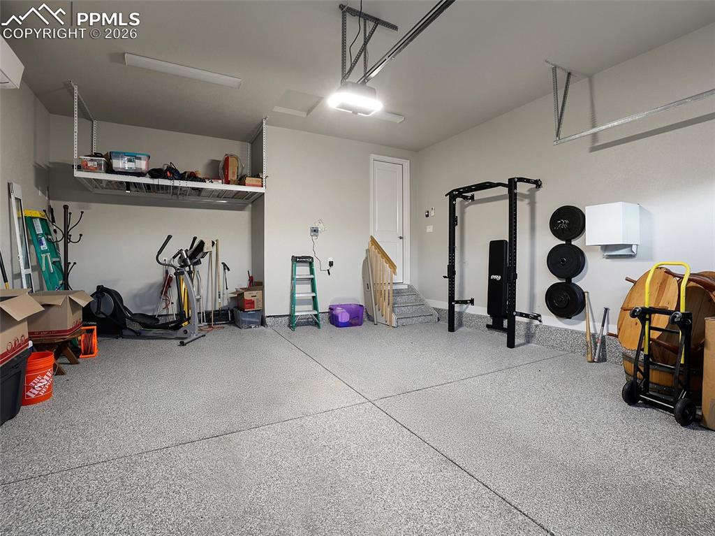 Image 46 of 47: heated and AC garage w/ workout equipment