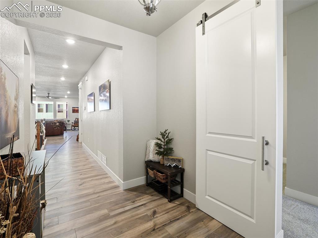 Image 6 of 47: front entry way and entrance into multi gen with barn door