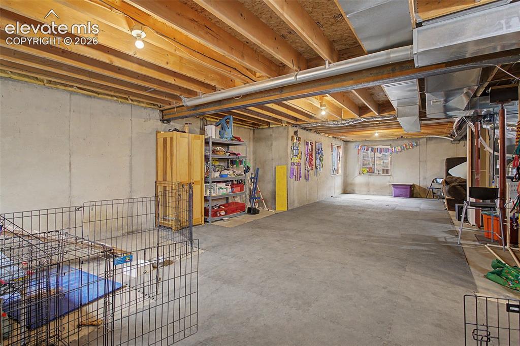 Image 33 of 45: Expansive unfinished basement featuring concrete flooring and walls, expose