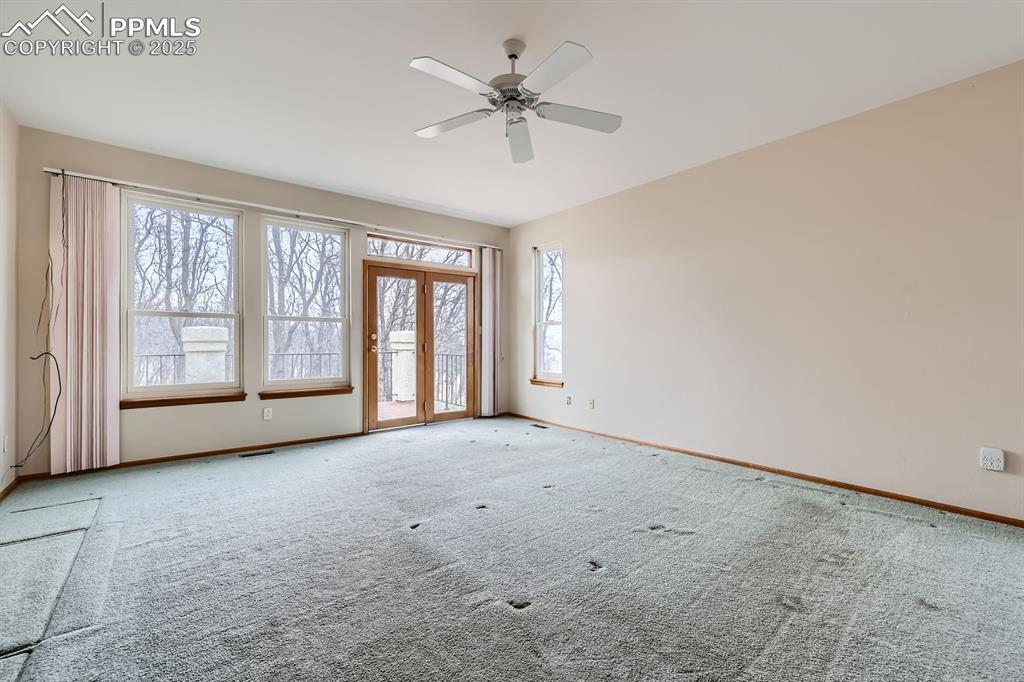 Image 14 of 31: Spare room featuring visible vents, carpet, baseboards, and ceiling fan