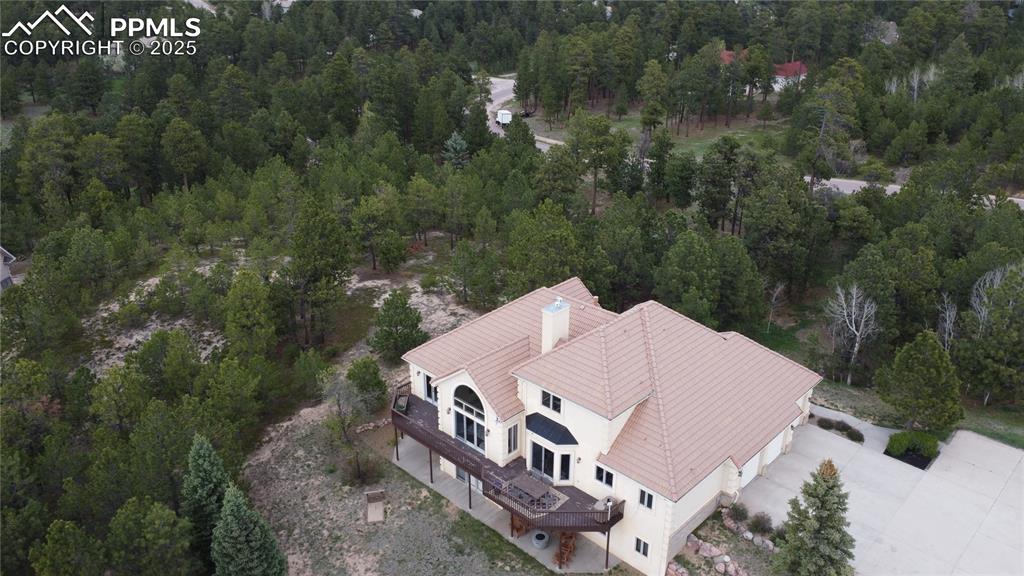 Image 37 of 37: View from above of property featuring a heavily wooded area