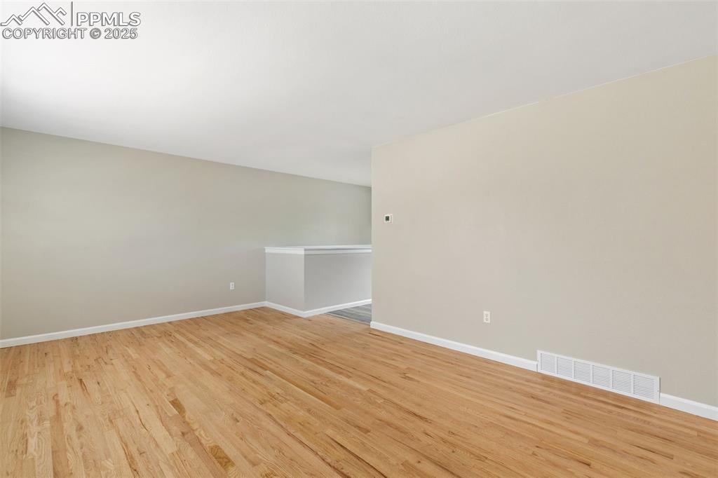 Image 29 of 50: New interior paint and refinished 2" oak flooring on main level.