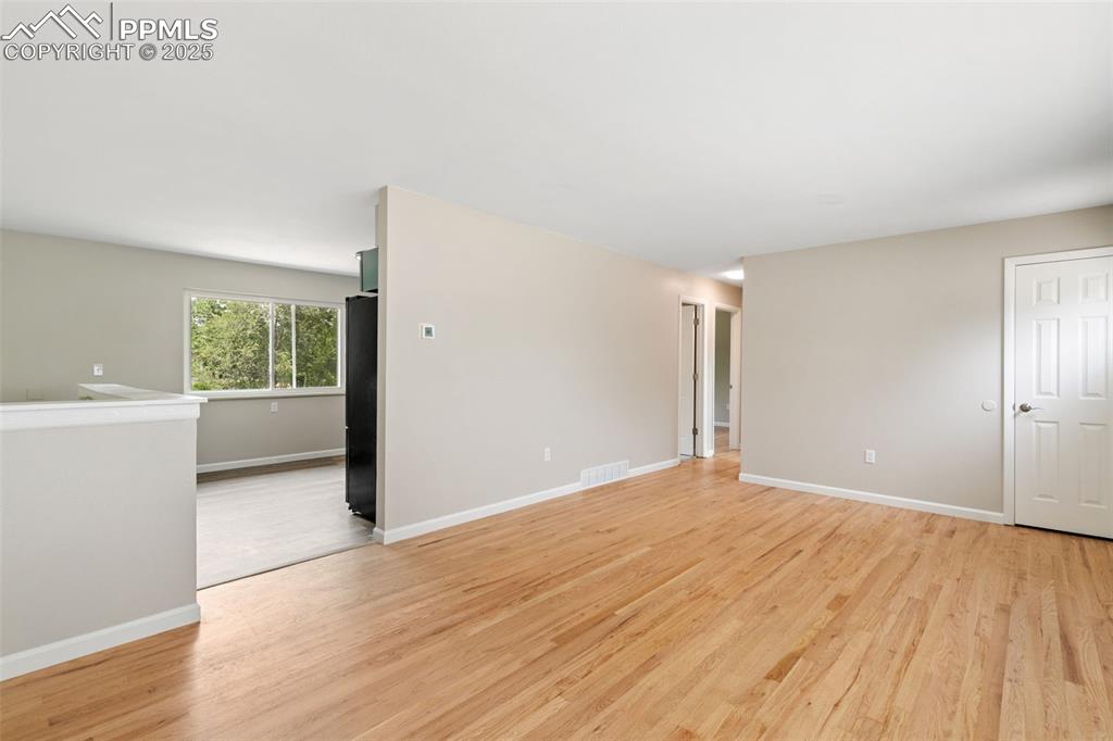 Image 30 of 50: New interior paint and refinished 2" oak flooring on main level.